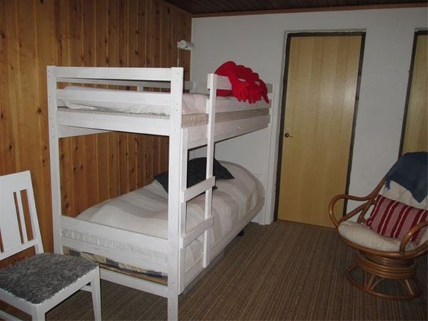 White bunk bed in cellar. 