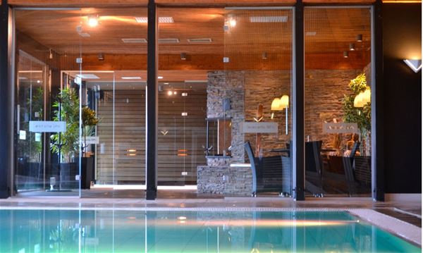Indoor pool in a room with large windows. 