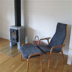 Armchair beside a fireplace