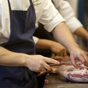 Chefs cutting meat. 