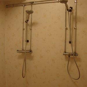 Two showers on the same wall. 