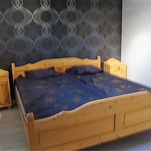 Double bed in a wooden frame. 