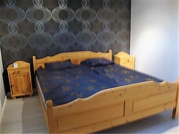 Double bed in a wooden frame.  