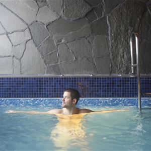 A man is bathing in the pool. 