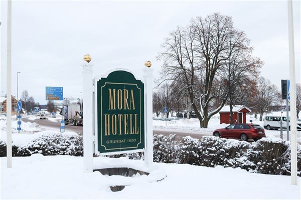 The hotel sign with snow on the top.  