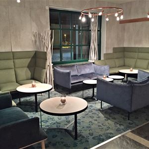 Lobby with blue and green sofas.