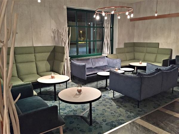 Lobby with blue and green sofas. 