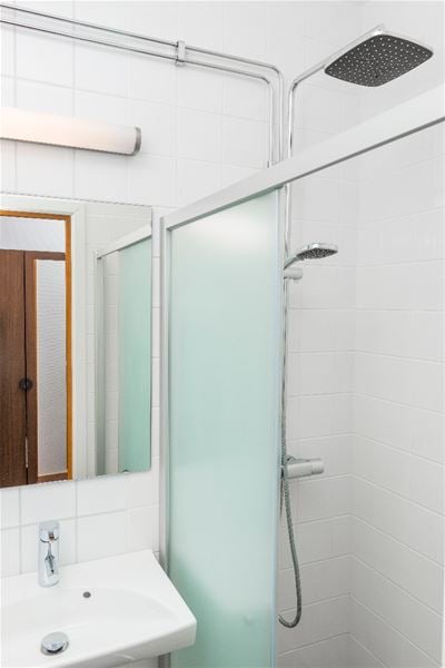 A shower with a glass wall. 