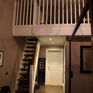 Room with a stair leading to a loft.