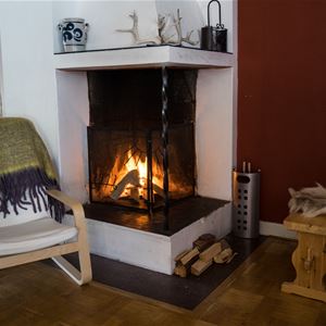 Fire place with a chair.