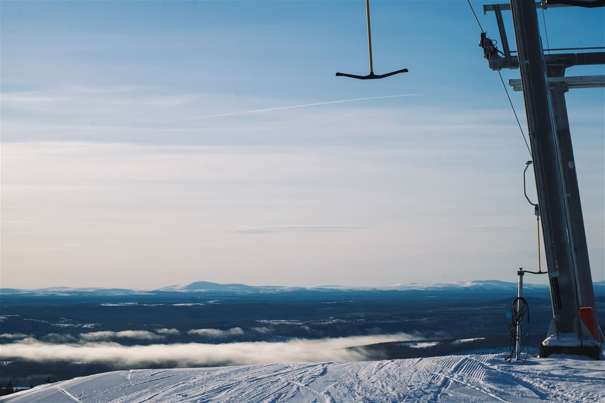 An anchor lift in the air, mountains in the background.