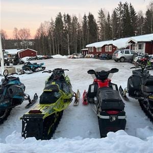 Snowmobiles on the parking place outside the hotel.