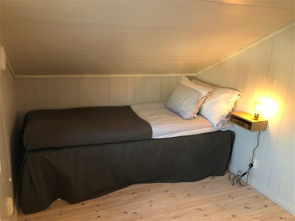 Single bed under sloping roof.  