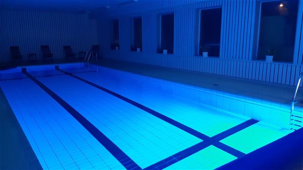 Indoor swimming pool in a blue light.  
