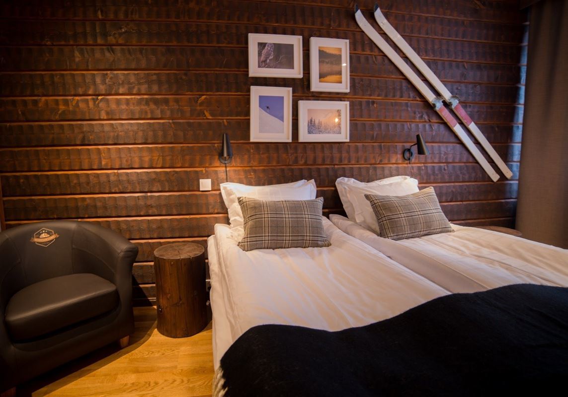 Bed at a timbered wall. 