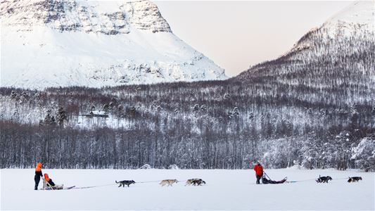 Sledding past big mountains
