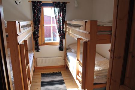 A bedroom with two bunk beds.
