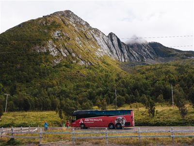 Photo of the Arctic Route bus travelling along the National Tourist Route on Senja