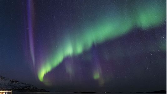 Purple and green northern lights in the sky