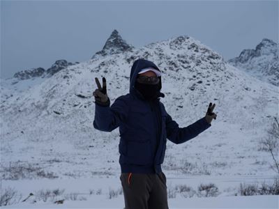 Guest poses in front of mountains