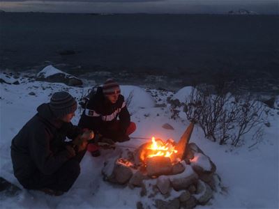 Guests sit by the fireplace