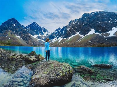 A guest stands beside the beautiful Blåisvatnet