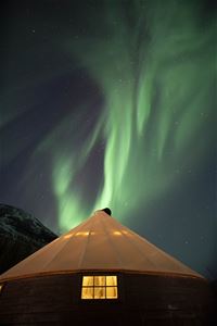 The Northern Lights show themselves above a lavvo