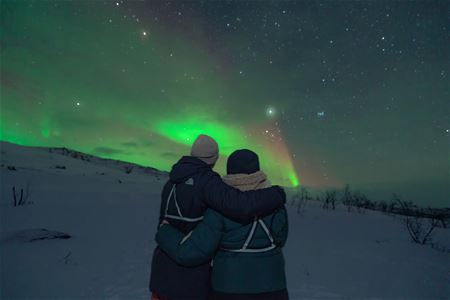 Two people watching Northern Lights