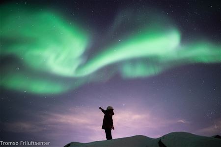 A guest pointing at the northern lights