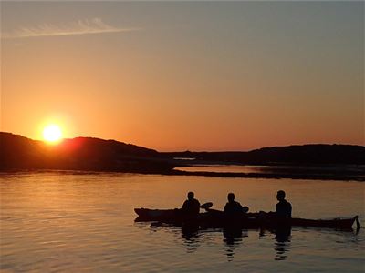 Three people on a kayak