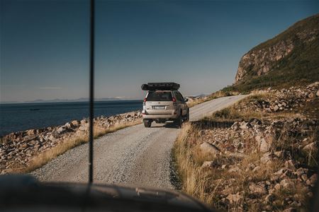Car driving on gravel road