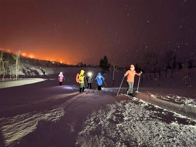 Guests out on snowshoeing trip at night