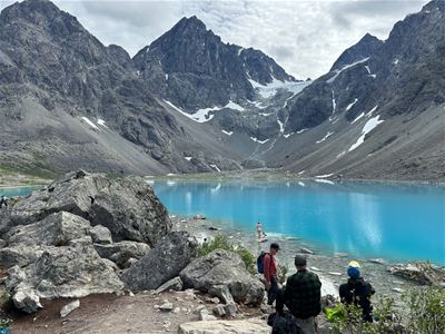 Guests sit by the water at the Blåisvatnet lake