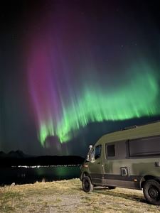 Northern Lights shine over the bus