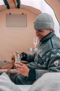 A person pouring a soda in a glass