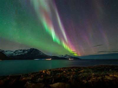 Northern lights reflects itself in the fjords