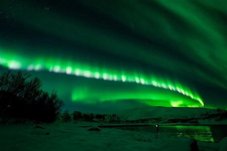 Camera on a tripod capturing the northern lights