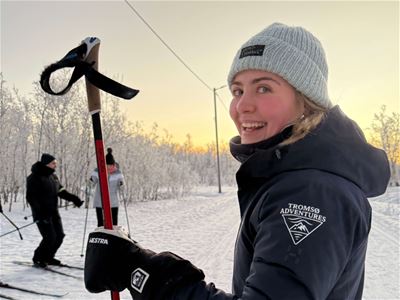 Smiling guide with ski poles