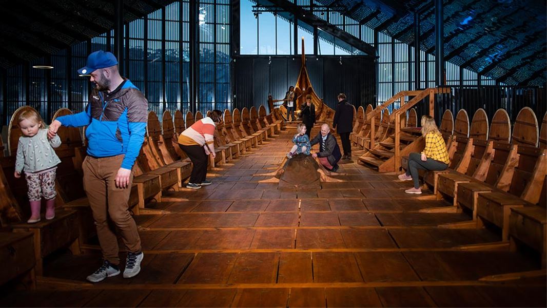 Guests exploring the Myklebust Ship from the inside at Sagastad Viking Center.