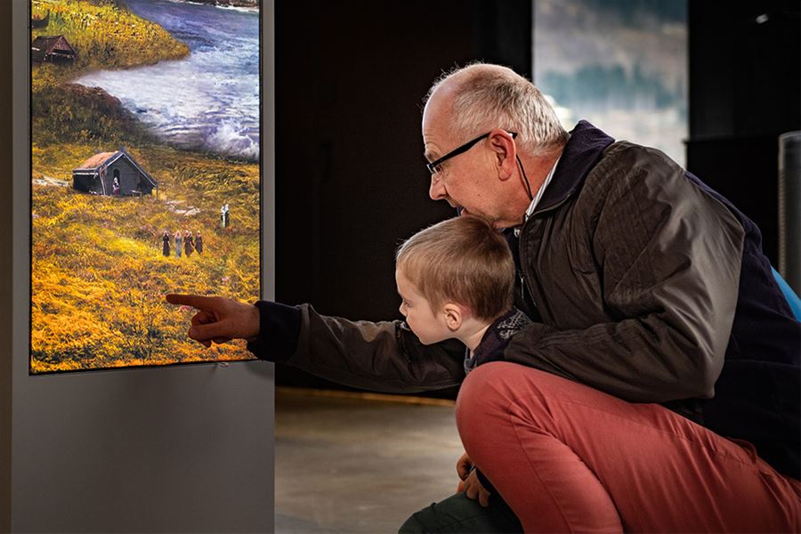 A child and grandfather exploring the exhibitions together at Sagastad Viking Center.