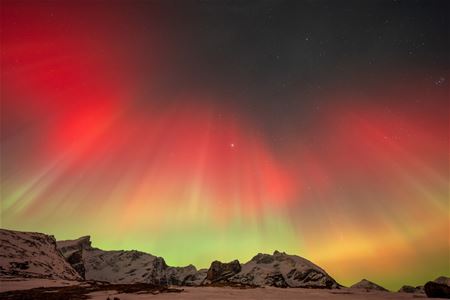 Red, orange and green Northern Lights light up the sky