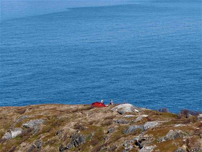 Persons camping out towards the sea
