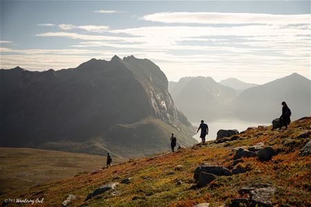 A group hiking with mountains in the background