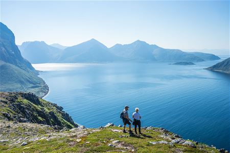 Two people enjoying the view over the sea and mountains