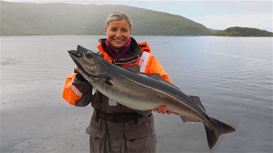 A woman holding a fish