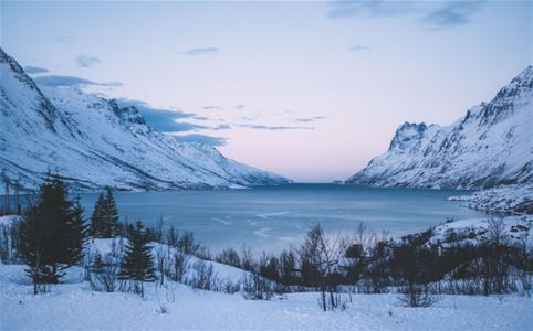 Fjord with mountains on both sides in winter