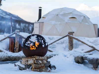 A campfire in front of a tent