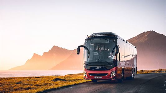 Red Arctic Route bus driving along a road