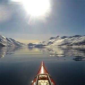 Utsikt over snødekte fjell fra en kajakk