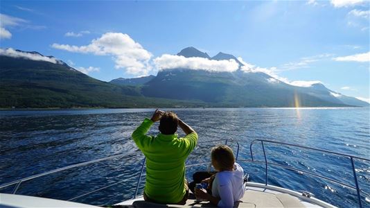 Two guests on the boat taking photos of the scenery